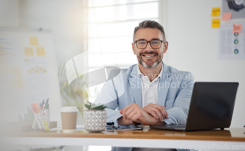 Image of Portrait of businessman at office desk with smile, laptop and tablet on business website, online report or social media. Internet, digital app and confident, mature man with workshop and web schedule
