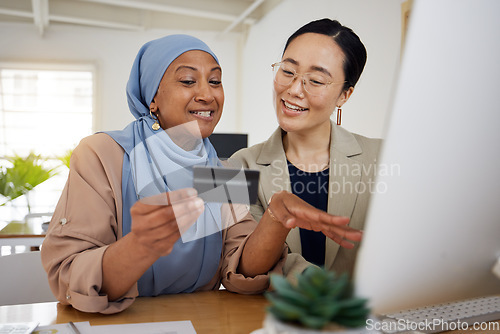 Image of Online shopping, credit card and business women or friends doing ecommerce or banking while talking together. Muslim, asian and professional consulting a customer on rewards purchase on website