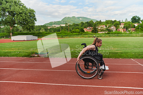 Image of A woman with disablity driving a wheelchair on a track while preparing for the Paralympic Games