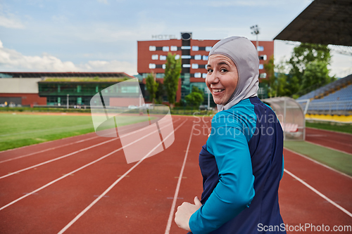 Image of A muslim woman in a burqa sports muslim clothes running on a marathon course and preparing for upcoming competitions