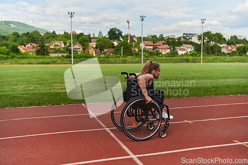 Image of A woman with disablity driving a wheelchair on a track while preparing for the Paralympic Games