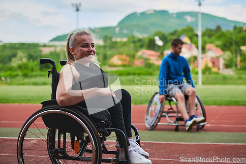 Image of A woman with disablity driving a wheelchair on a track while preparing for the Paralympic Games