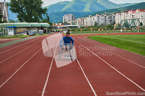 Image of A person with disability in a wheelchair training tirelessly on the track in preparation for the Paralympic Games