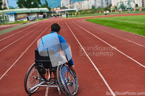 Image of A person with disability in a wheelchair training tirelessly on the track in preparation for the Paralympic Games