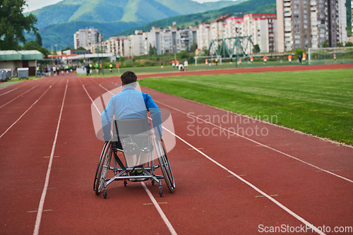 Image of A person with disability in a wheelchair training tirelessly on the track in preparation for the Paralympic Games