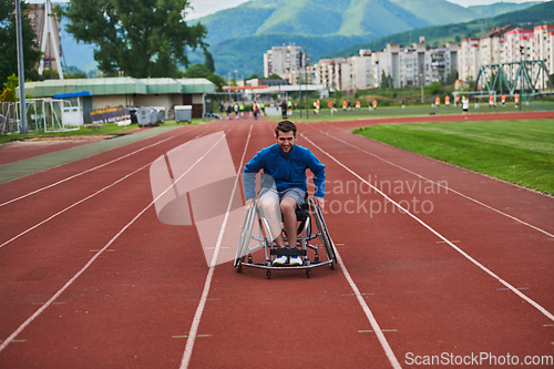 Image of A person with disability in a wheelchair training tirelessly on the track in preparation for the Paralympic Games