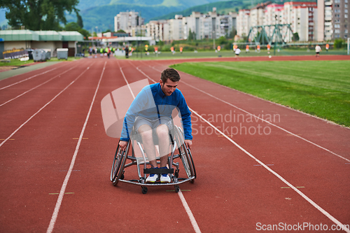 Image of A person with disability in a wheelchair training tirelessly on the track in preparation for the Paralympic Games