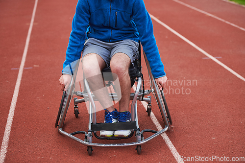 Image of A person with disability in a wheelchair training tirelessly on the track in preparation for the Paralympic Games