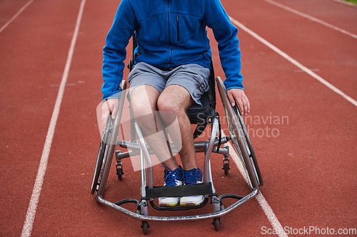 Image of A person with disability in a wheelchair training tirelessly on the track in preparation for the Paralympic Games