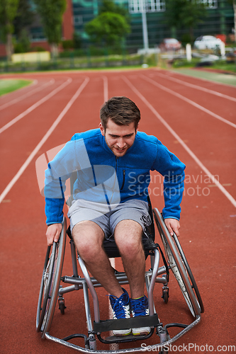 Image of A person with disability in a wheelchair training tirelessly on the track in preparation for the Paralympic Games