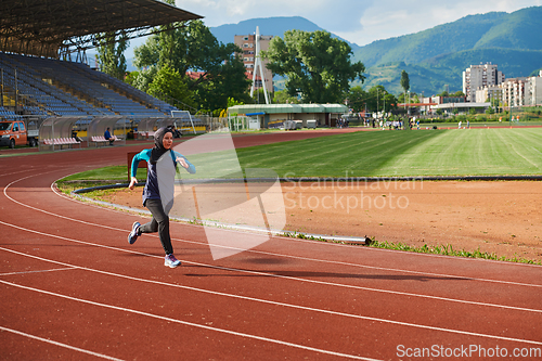 Image of A muslim woman in a burqa sports muslim clothes running on a marathon course and preparing for upcoming competitions