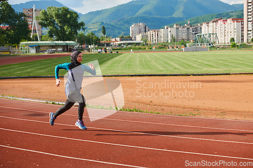 Image of A muslim woman in a burqa sports muslim clothes running on a marathon course and preparing for upcoming competitions