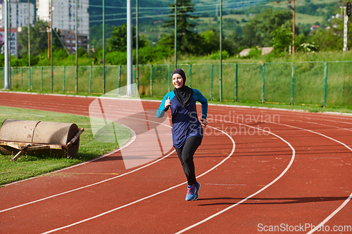 Image of A muslim woman in a burqa sports muslim clothes running on a marathon course and preparing for upcoming competitions