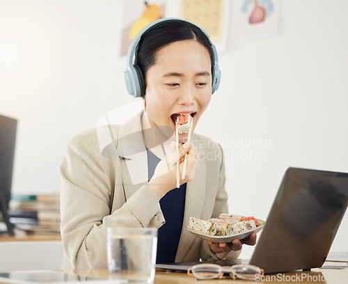 Image of Fast food, delivery and asian woman with laptop in office for lunch break, eating and meal. Sushi, brunch and Japanese designer online with positive review, survey or feedback for takeout service