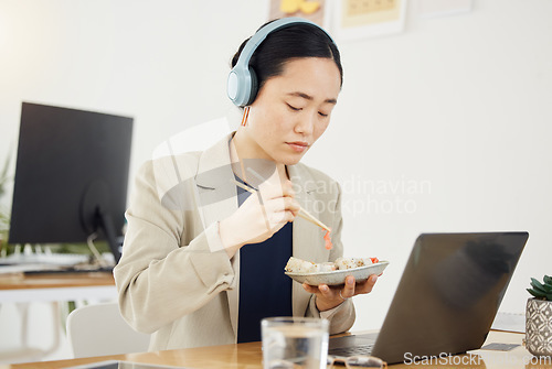 Image of Break, food and asian woman, call center or lunch with laptop in office while consulting for crm, contact us or faq. Customer service, telemarketing and lead generation consultant online eating sushi