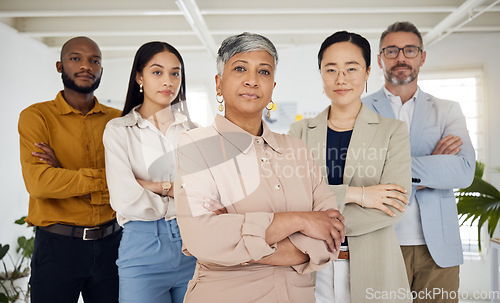 Image of Business people, serious and arms crossed portrait in a office with diversity and senior woman ceo. Company, management team and confidence of professional leadership and creative agency group