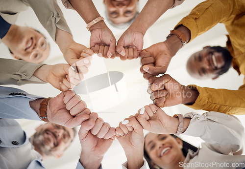 Image of Team building, fist bump and business people portrait in office for teamwork, support or faith from below. Diversity, hands and team face together sign for union, trust and partnership or motivation