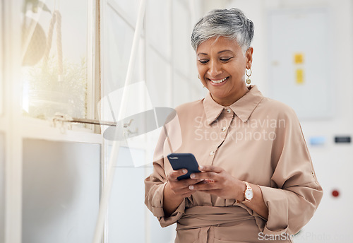Image of Senior woman, phone text and networking in a office with a smile and mobile planning for digital work. Person, female professional and happy from contact and social media scroll for business online