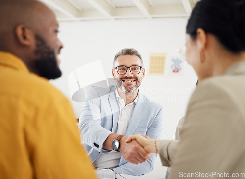 Image of Happy business people, handshake and interview in meeting, hiring or corporate growth at the office. Group of employees shaking hands in teamwork, recruiting or b2b deal for partnership at workplace