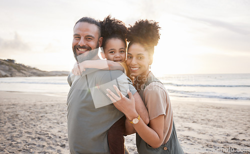 Image of Portrait, hug and family with sunset, beach and love with vacation, journey and ocean getaway. Happy parents, mother or father with girl, child or embrace with seaside holiday, adventure and travel