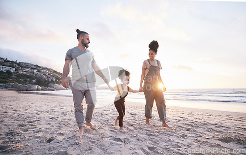 Image of Holding hands, family and walk on beach at sunset, bonding and mockup space. Father, mother and happy kid at ocean in interracial care, love or smile on vacation, holiday or summer travel together
