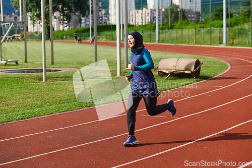 Image of A muslim woman in a burqa sports muslim clothes running on a marathon course and preparing for upcoming competitions