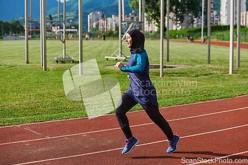 Image of A muslim woman in a burqa sports muslim clothes running on a marathon course and preparing for upcoming competitions