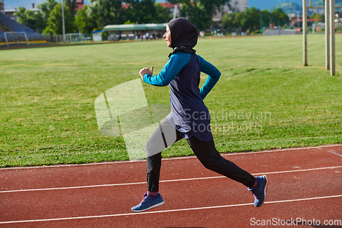 Image of A muslim woman in a burqa sports muslim clothes running on a marathon course and preparing for upcoming competitions