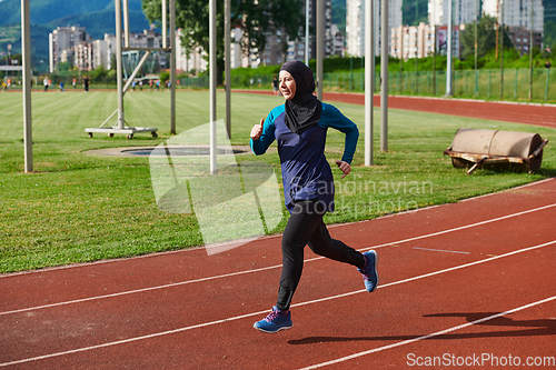 Image of A muslim woman in a burqa sports muslim clothes running on a marathon course and preparing for upcoming competitions