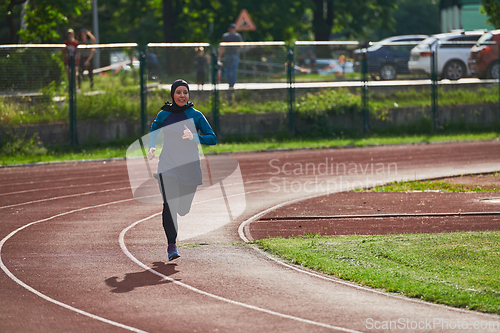 Image of A muslim woman in a burqa sports muslim clothes running on a marathon course and preparing for upcoming competitions