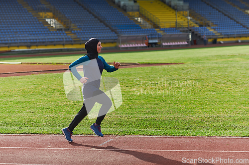 Image of A muslim woman in a burqa sports muslim clothes running on a marathon course and preparing for upcoming competitions