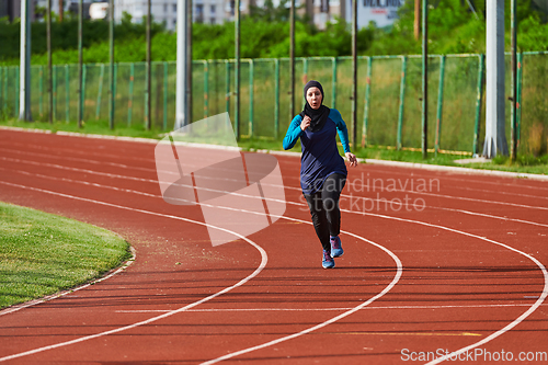 Image of A muslim woman in a burqa sports muslim clothes running on a marathon course and preparing for upcoming competitions