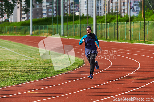 Image of A muslim woman in a burqa sports muslim clothes running on a marathon course and preparing for upcoming competitions