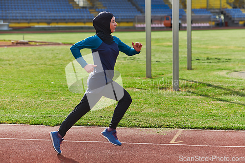 Image of A muslim woman in a burqa sports muslim clothes running on a marathon course and preparing for upcoming competitions