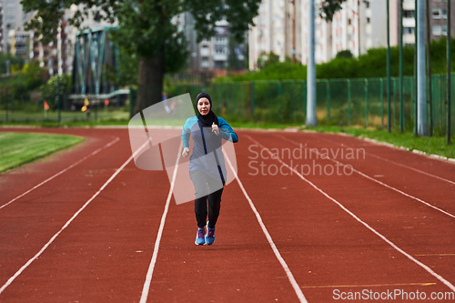 Image of A muslim woman in a burqa sports muslim clothes running on a marathon course and preparing for upcoming competitions