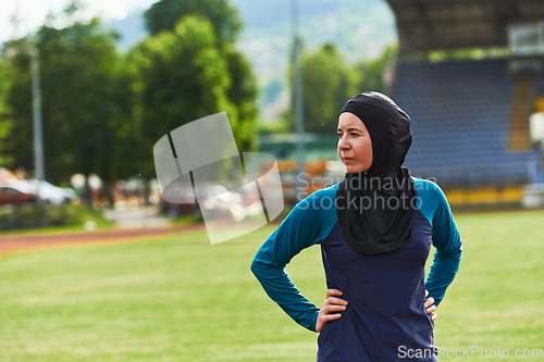 Image of A Muslim woman with a burqa, an Islamic sportswoman resting after a vigorous training session on the marathon course. A hijab woman is preparing for a marathon competition