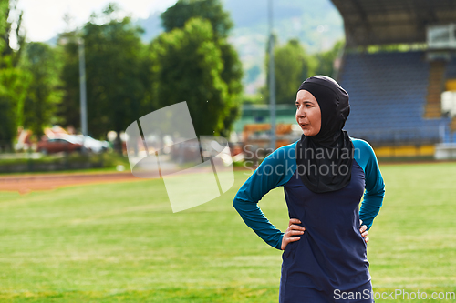 Image of A Muslim woman with a burqa, an Islamic sportswoman resting after a vigorous training session on the marathon course. A hijab woman is preparing for a marathon competition