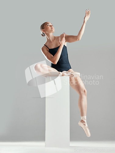 Image of Performance, ballerina or woman on block in studio in creative routine or elegant act for art or freedom. Girl, dancer or classy ballet dancing or training to exercise on platform or white background