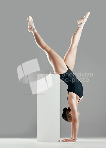 Image of Balance, ballet or woman in studio on a handstand, block or platform for elegant routine or creative freedom. Flexible, dancer or girl ballerina dancing or training to exercise on white background