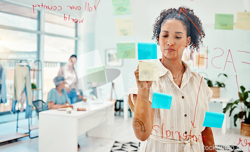 Image of Creative woman, fashion designer and writing in schedule planning, strategy or idea on glass board at the office. Female person in retail startup, project plan or brainstorming tasks at the workplace