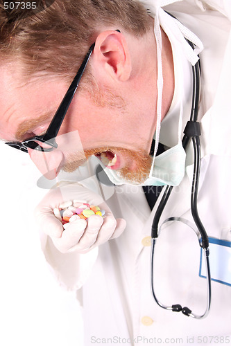 Image of doctor taking hand full of tablets 