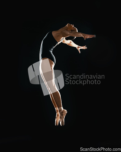 Image of Art, ballet jumping and woman on black background in dance performance with balance, action and talent. Dark aesthetic, flexible ballerina or dancer training with fitness, creativity and studio show.