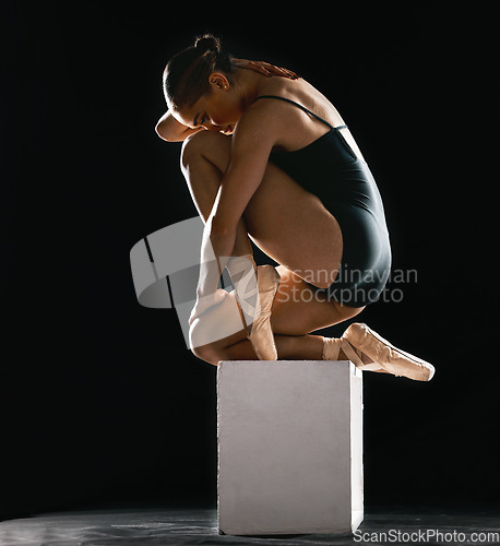 Image of Beauty, ballet and art with woman in studio for dance, performance and theater. Health, energy and creative with ballerina and balance on pedestal on black background for stage, grace and elegance