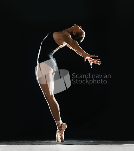 Image of Art, ballet and woman on black background in dance performance with balance, stretching and talent. Dark aesthetic, flexible ballerina or dancer training with fitness, creativity and studio exercise.