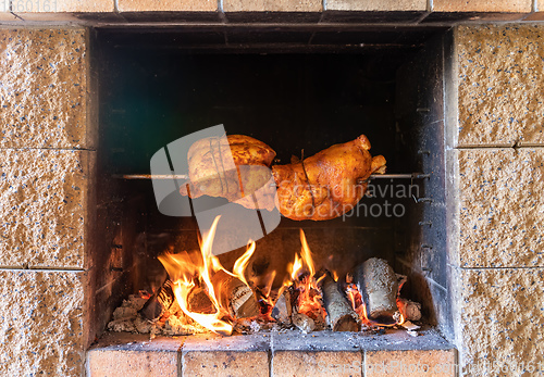 Image of chicken roasting on a spit