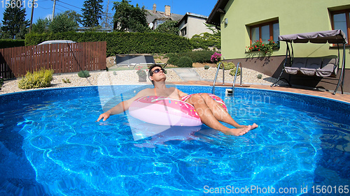 Image of Happy man relax on inflatable ring. Holiday 2020