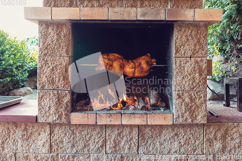 Image of chicken roasting on a spit