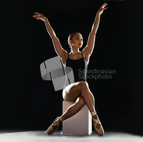 Image of Creative, ballet and art with woman in studio for dance, performance and theater. Health, energy and beauty with ballerina and balance on pedestal on black background for stage, grace and elegance