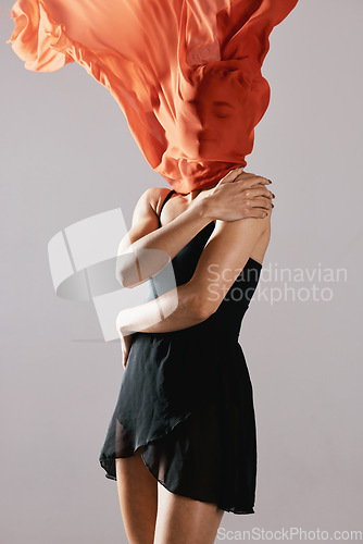 Image of Fashion, fabric and wind with a model in studio on a gray background for runway or magazine cover style. Abstract, textile and hidden face with a trendy young woman posing in a material outfit