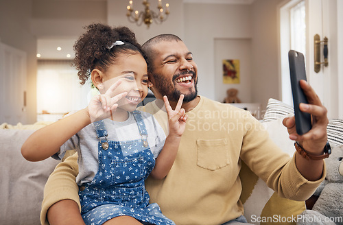 Image of Selfie, happy and a father and child with a peace sign on the sofa for social media or a video call. Smile, family and a dad taking a photo with a girl kid and a gesture for live streaming in a house